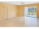 Spacious living room with tile flooring and sliding glass doors to an enclosed lanai at 10346 Carrollwood Ln # 171, Tampa, FL 33618