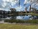 View of a pond with clear reflection of the building, blue sky, and clouds at 10346 Carrollwood Ln # 171, Tampa, FL 33618