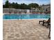 Community pool area with lounge chairs at 10346 Carrollwood Ln # 171, Tampa, FL 33618