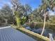 View from a wooden deck of a backyard with a pond at 11935 Riverhills Dr, Temple Terrace, FL 33617