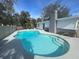 Backyard featuring a large pool with a stone chimney in the background at 11935 Riverhills Dr, Temple Terrace, FL 33617