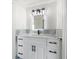 Bright bathroom boasts white vanity, black hardware, modern mirror and decorative tile backsplash at 124 Leeward Is, Clearwater Beach, FL 33767