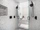 Elegant bathroom featuring dual showers, herringbone tile walls, and seamless glass door at 124 Leeward Is, Clearwater Beach, FL 33767