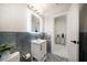 Contemporary bathroom featuring sleek vanity, modern fixtures, unique tile accents, and bright, neutral colors at 124 Leeward Is, Clearwater Beach, FL 33767