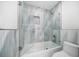 Contemporary bathroom features glass-enclosed tub and tiled walls at 124 Leeward Is, Clearwater Beach, FL 33767