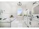 Well-lit bathroom with a soaking tub, dual vanities, arched window and chic black fixtures at 124 Leeward Is, Clearwater Beach, FL 33767