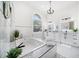 Luxurious bathroom featuring a soaking tub, dual vanities, and elegant lighting at 124 Leeward Is, Clearwater Beach, FL 33767