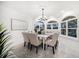 Elegant dining room with modern chandelier, large windows, and seating for eight provides perfect space for entertaining at 124 Leeward Is, Clearwater Beach, FL 33767