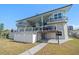 Exterior view of home, including porch, balconies, spiral staircase, and yard at 124 Leeward Is, Clearwater Beach, FL 33767