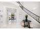 Bright and airy foyer featuring a grand staircase and a view into the spacious living area at 124 Leeward Is, Clearwater Beach, FL 33767