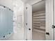 Hallway leading to walk-in closet featuring a frosted glass partition and elegant white finishes at 124 Leeward Is, Clearwater Beach, FL 33767