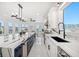 Bright kitchen with an island with seating and modern appliances, adjacent to the canal at 124 Leeward Is, Clearwater Beach, FL 33767