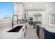 Bright white kitchen featuring countertops with designer backsplash and modern stainless steel appliances at 124 Leeward Is, Clearwater Beach, FL 33767