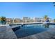 View of inground pool overlooking water, buildings across the canal and fence on a sunny day at 124 Leeward Is, Clearwater Beach, FL 33767