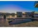 Backyard pool overlooking waterfront with views of nearby condos at sunset at 124 Leeward Is, Clearwater Beach, FL 33767