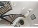 Elegant curved staircase features black iron railings and leads to the main living area with bright, natural light at 124 Leeward Is, Clearwater Beach, FL 33767