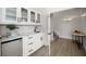 Bright wet bar featuring white cabinetry, stylish fixtures, and a convenient mini-fridge for entertaining at 124 Leeward Is, Clearwater Beach, FL 33767