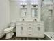 Elegant bathroom with double vanity, tiled shower, and contemporary lighting fixtures at 16417 Lake Byrd Dr, Tampa, FL 33618