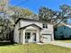 Two-story home featuring stucco siding, covered entryway, attached garage and healthy landscaping at 16417 Lake Byrd Dr, Tampa, FL 33618