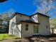 Back exterior of the home with a manicured lawn at 16417 Lake Byrd Dr, Tampa, FL 33618