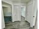 Hallway with wood-look floors and white doors at 16417 Lake Byrd Dr, Tampa, FL 33618