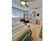 Cozy bedroom featuring a ceiling fan, neutral carpet, and wicker furnishings complemented by natural light from the window at 1656 S Lake Ave # 3, Clearwater, FL 33756