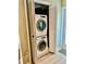 Conveniently located stackable washer and dryer unit with white bi-fold doors, perfect for small spaces at 1656 S Lake Ave # 3, Clearwater, FL 33756