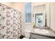 Bathroom featuring a granite countertop, a shower with patterned curtain, and natural light at 16631 Mooner Plank Cir Cir, Wimauma, FL 33598