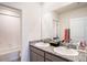 Bathroom featuring double vanity, granite countertop, large mirror, and tub with shower at 16631 Mooner Plank Cir Cir, Wimauma, FL 33598