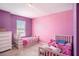 bedroom featuring two twin beds, bright pink walls, neutral carpet and lots of natural light at 16631 Mooner Plank Cir Cir, Wimauma, FL 33598