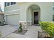 Inviting front entryway with a dark front door framed by stone accents and manicured landscaping at 16631 Mooner Plank Cir Cir, Wimauma, FL 33598