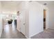 Bright hallway featuring tile flooring leading to the living area and carpeted flooring at 16631 Mooner Plank Cir Cir, Wimauma, FL 33598