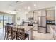 Modern kitchen featuring stainless steel appliances, a center island with seating, and bright lighting at 16631 Mooner Plank Cir Cir, Wimauma, FL 33598