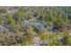 Estate aerial view showing sprawling property surrounded by lush trees at 17480 Nuthatch Rd, Weeki Wachee, FL 34614