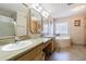 Bathroom featuring dual sinks, a glass block window and a jetted tub for relaxing at 17480 Nuthatch Rd, Weeki Wachee, FL 34614