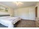 Bedroom features neutral carpet, a ceiling fan, and a light color scheme at 17480 Nuthatch Rd, Weeki Wachee, FL 34614