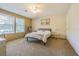 Bedroom features a large window, ceiling fan, and neutral carpet at 17480 Nuthatch Rd, Weeki Wachee, FL 34614