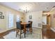 This bright dining room offers French doors to the rear yard, chandelier, and room for four at 17480 Nuthatch Rd, Weeki Wachee, FL 34614