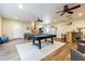 Large living room featuring a pool table, wood flooring, and modern furniture at 17480 Nuthatch Rd, Weeki Wachee, FL 34614