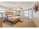 Spacious main bedroom with a wooden bed frame, ceiling fan and neutral colored walls at 17480 Nuthatch Rd, Weeki Wachee, FL 34614