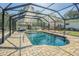 Enclosed pool with blue water, clear views, and a large patio area at 17480 Nuthatch Rd, Weeki Wachee, FL 34614