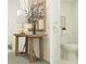 Bathroom featuring a wooden table and decorative vase near the sink at 17606 Happytrails St, Land O Lakes, FL 34638