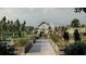 Scenic community garden with raised beds, lush greenery, and charming barn at 17606 Happytrails St, Land O Lakes, FL 34638