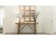 Hallway table with decorative mirror, lamp, books, and flowers at 17606 Happytrails St, Land O Lakes, FL 34638