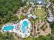 Bird's-eye view of the pool and playground area, set within a beautiful, wooded community at 17628 Breakaway St, Land O Lakes, FL 34638