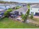 Aerial view of backyard featuring a screened-in lanai, lounge area, and well-maintained lawn at 17628 Breakaway St, Land O Lakes, FL 34638