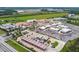 Aerial view of community development, showing retail spaces, construction and surrounding landscape at 17628 Breakaway St, Land O Lakes, FL 34638