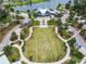 High-angle view of a large grass field with a building and small lake at 17628 Breakaway St, Land O Lakes, FL 34638