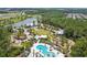 High angle view of a pool with a water feature and a clubhouse overlooking a landscaped yard at 17628 Breakaway St, Land O Lakes, FL 34638