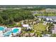 Expansive aerial view showcases the pool, clubhouse, and lush surroundings at 17628 Breakaway St, Land O Lakes, FL 34638